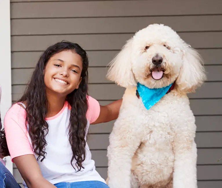 Family sitting on the porch with their dog | Southern Pest Control serving Mississippi Gulf Coast